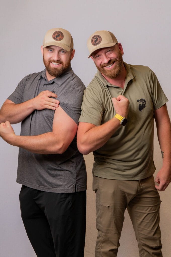 Jason and Brian posing with their muscles flexed for the camera